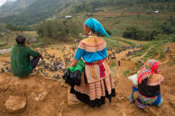 Overlooking Can Cau buffalo market / Two H'mong women and a H'mong man looking down on the buffalo market in Can Cau, Vietman